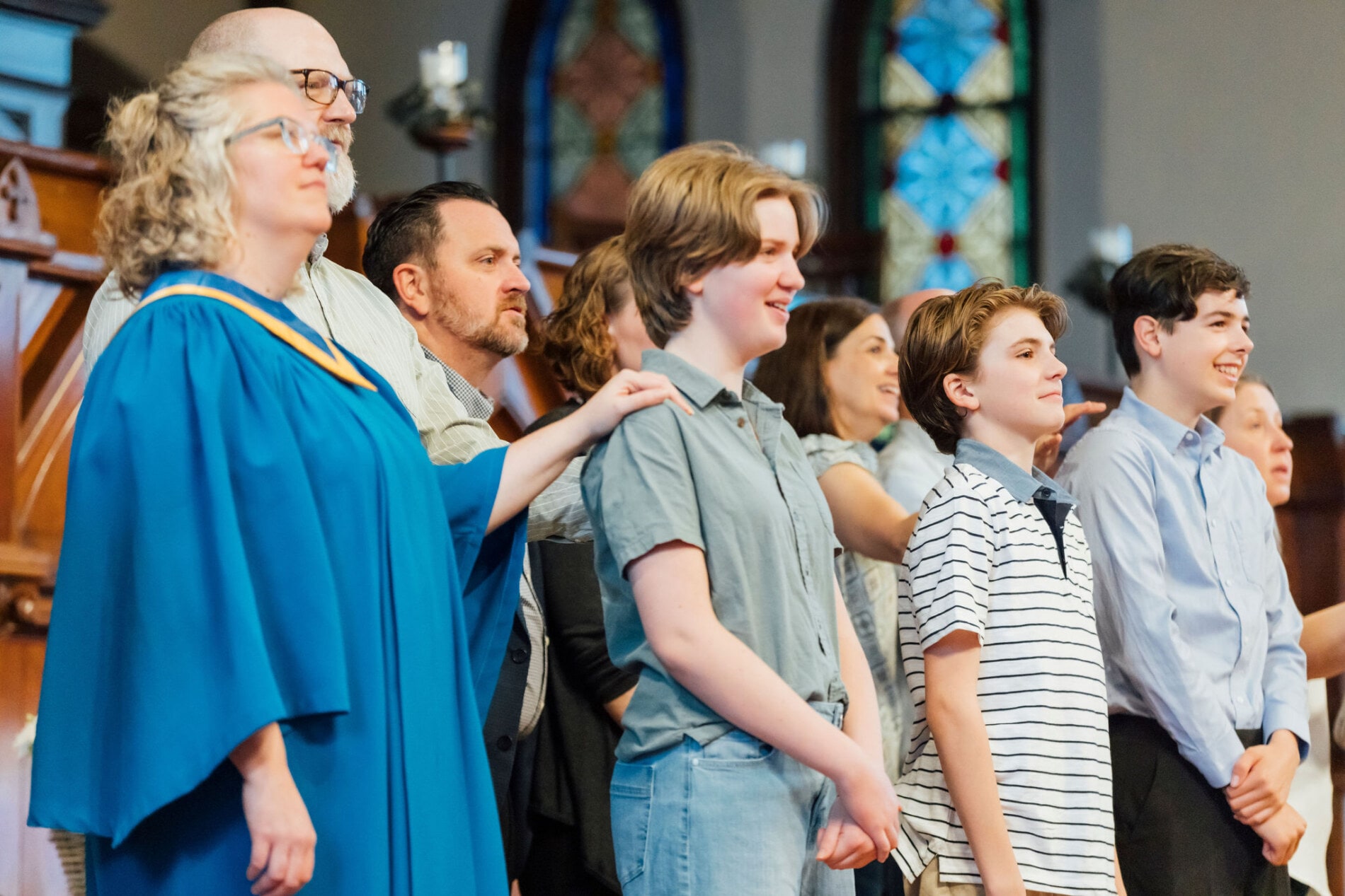 A group of teenagers and adults standing at the front of a church