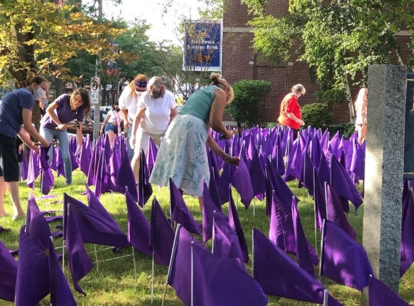 Planting hundreds of purple flags in the church lawn.