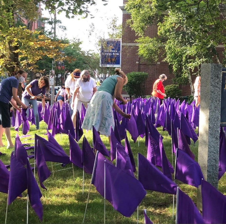 Planting hundreds of purple flags in the church lawn.