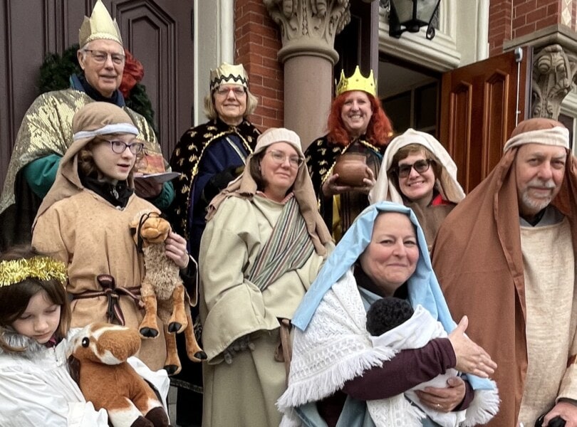 Carolers dressed up as a Living Creche manger scene.
