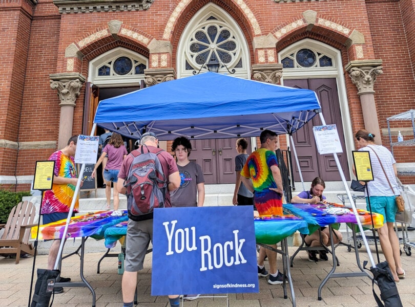 An activity tent in front of the church with sign that says "You Rock!"