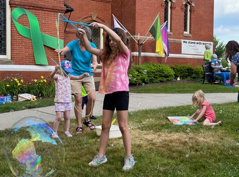 Children making giant soap bubbles