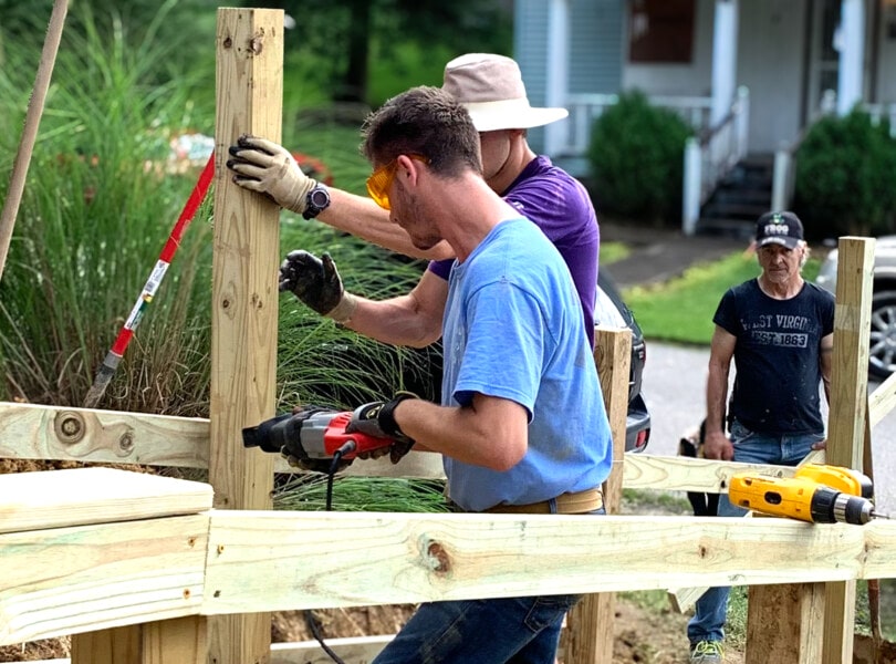 A group of volunteers building a railing