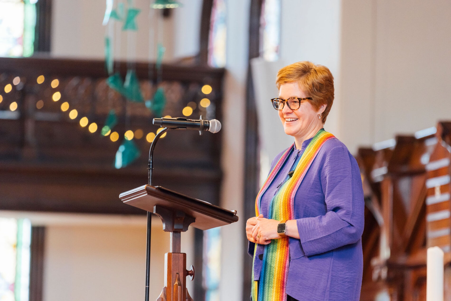 A pastor wearing a rainbow stole