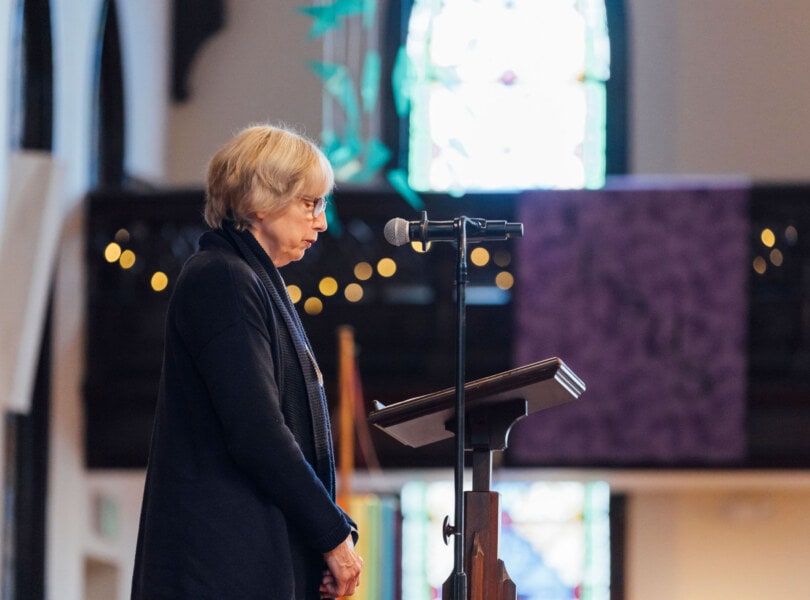 A woman leading the congregation during a reading
