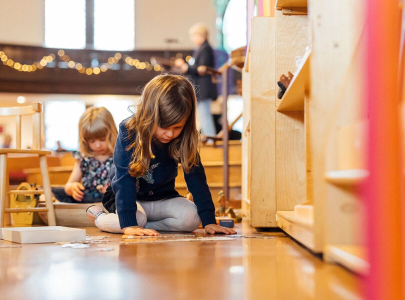 A child playing on the floor of a church