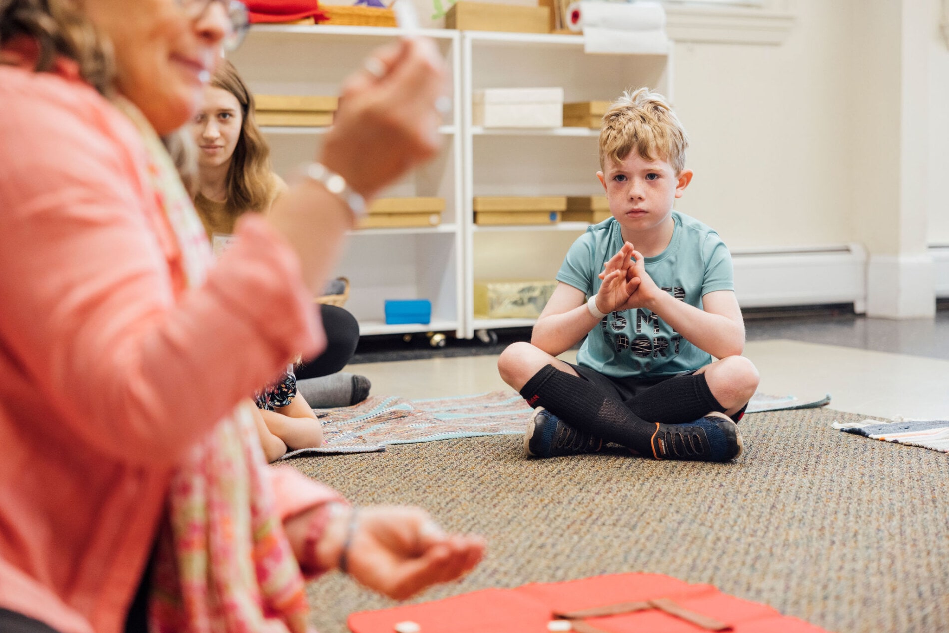 A young boy listens to his Sunday School teacher