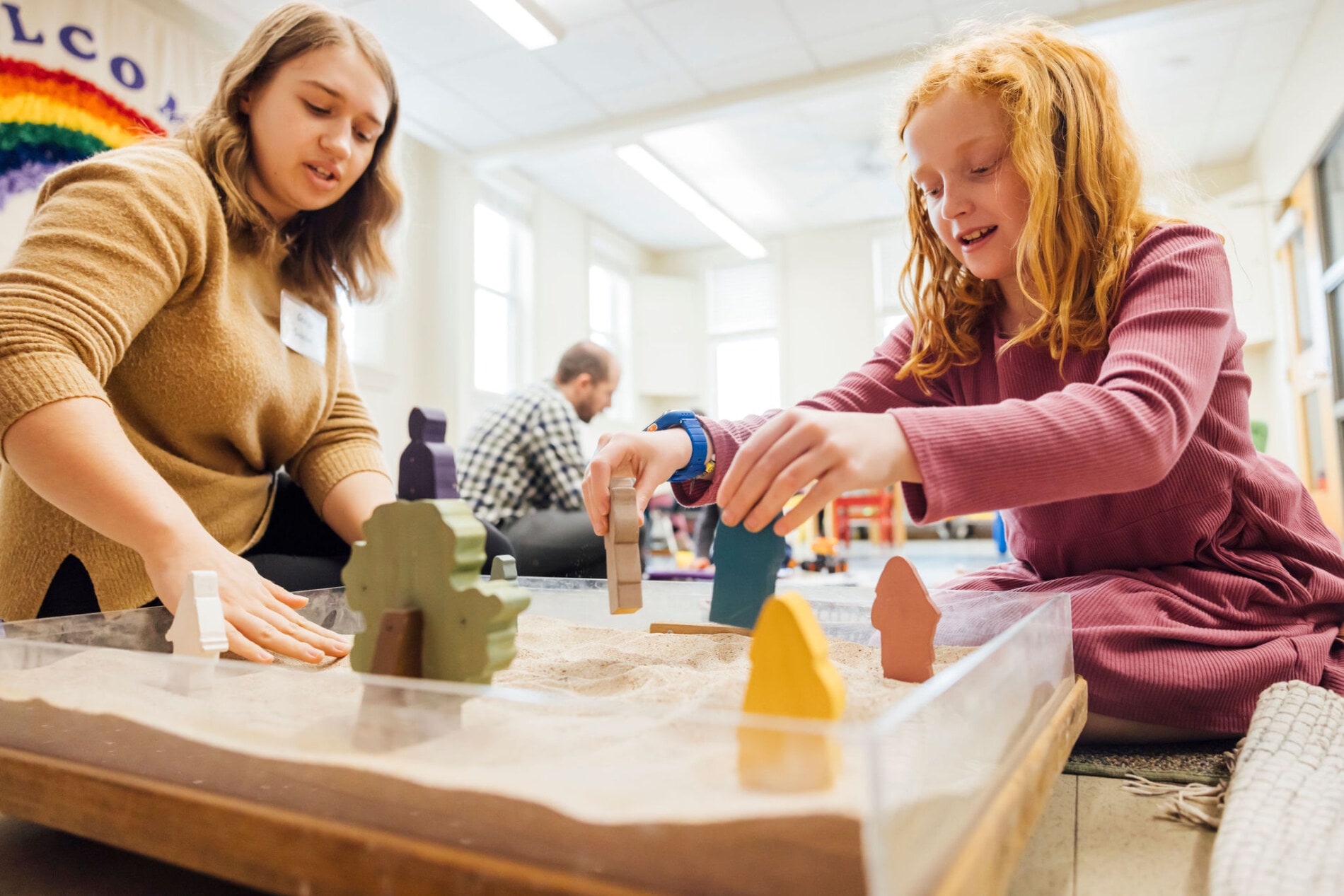 Children playing with sand and figurines in Sunday School