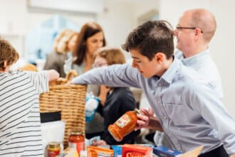 A teenager helps collect food for the hungry