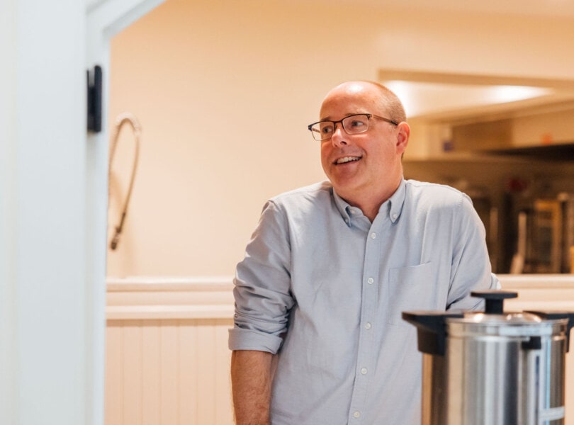 A man in front of a coffee maker