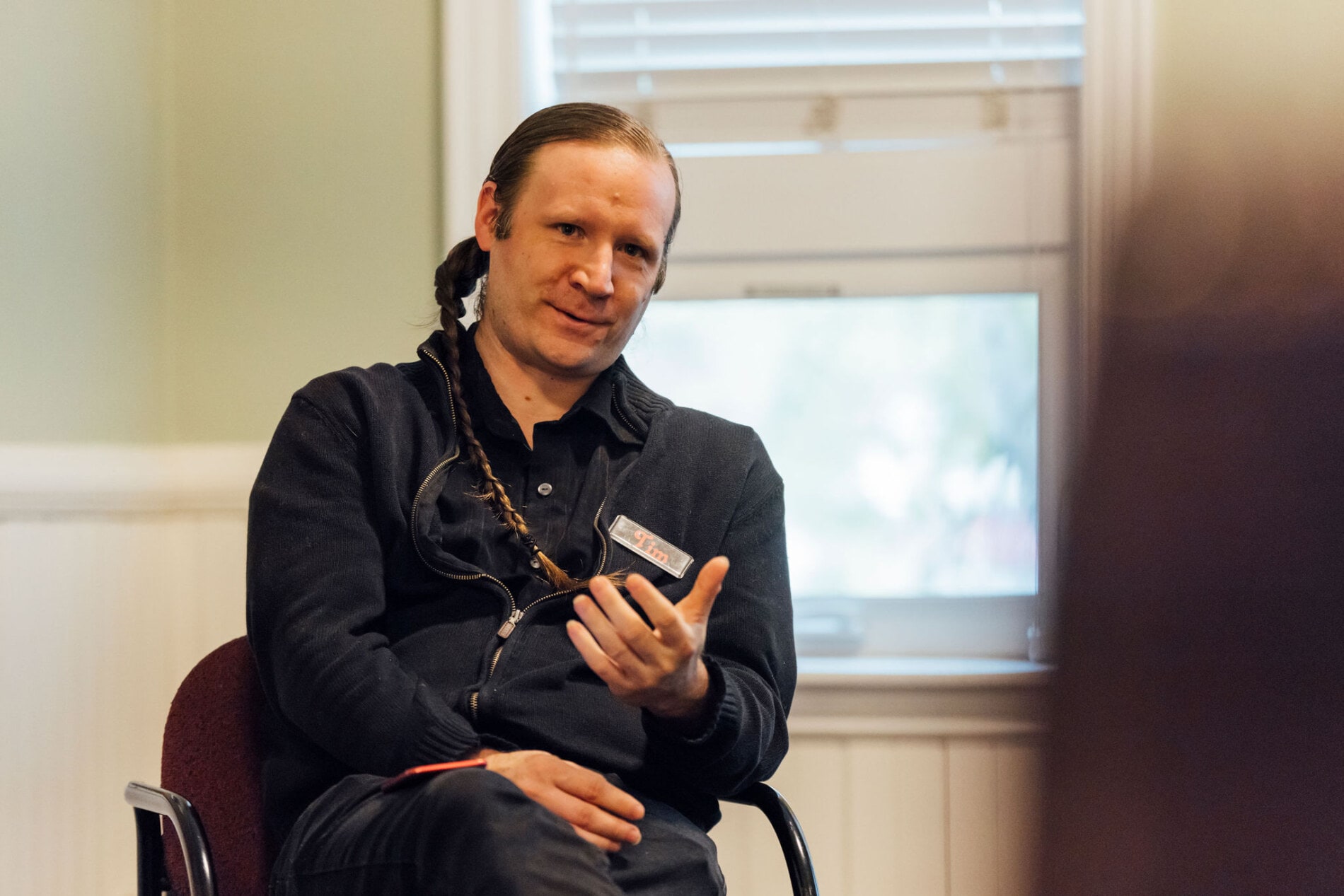 A man speaks and gestures with his hands during a Bible study