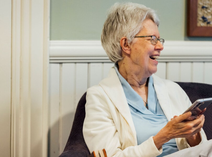 A woman smiling in a group discussion