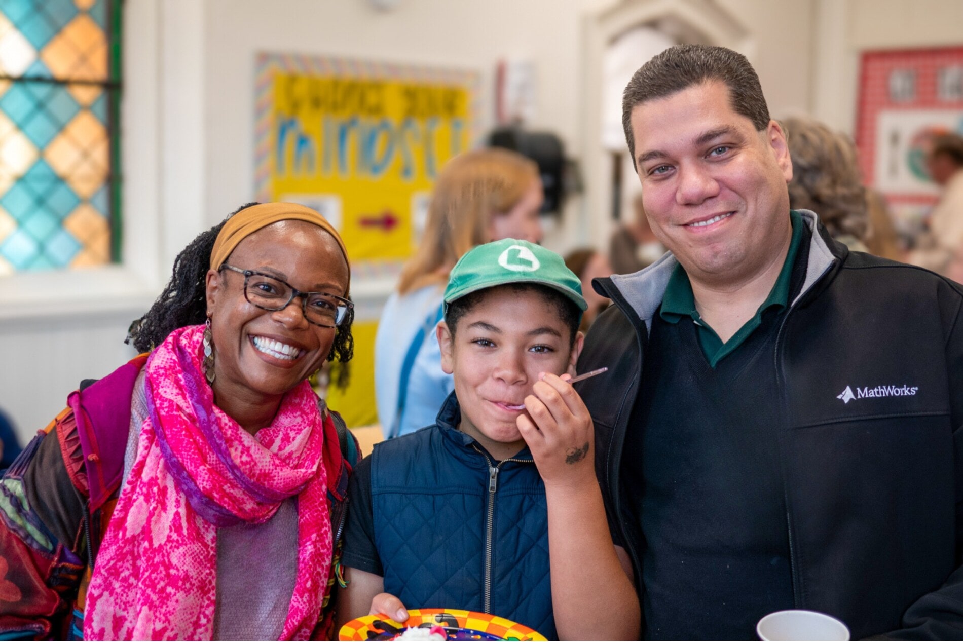 Two parents and their child at coffee hour
