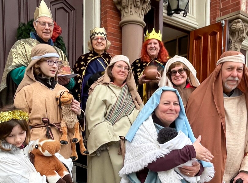 Carolers dressed up as a Living Creche manger