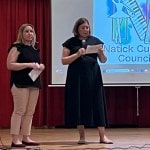 Two women speaking on stage.