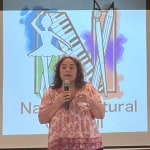 Woman speaking on stage.