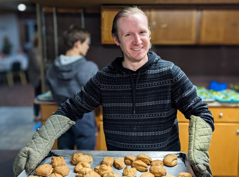 A man holds a tray of food