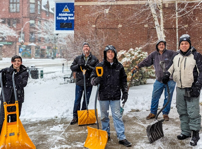 4 men and a boy with snow shovels