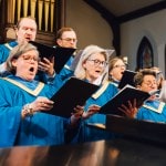 Choir in blue and gold robes singing