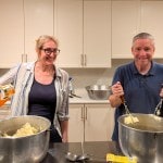 Man and woman mashing 30 pounds of potatoes