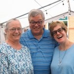 Happy couple and pastor at the church barbeque.