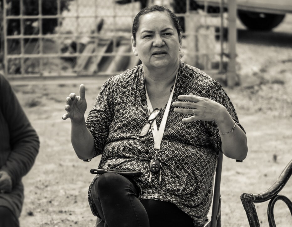 Close up of a woman in a chair talking.