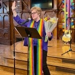 Pastor giving a blessing while holding a bouquet