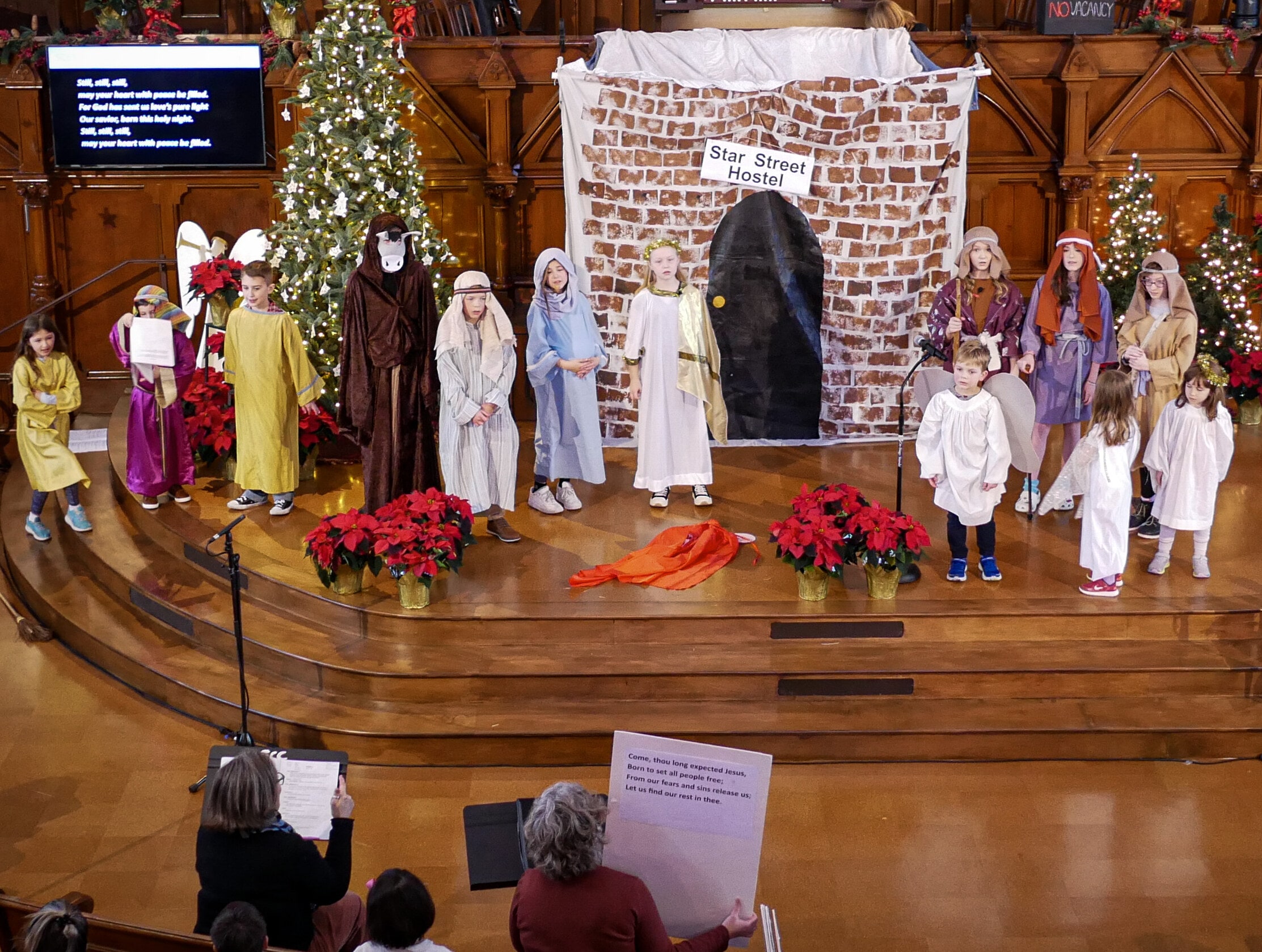 pageant2023b children on a stage performing a Christmas Pageant.