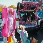 Women in a barbie costume, including the box.