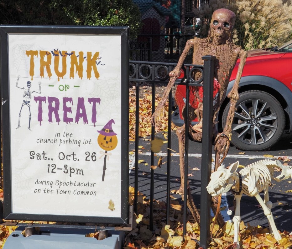 Trunk or Treat sign next to human and dog skeletons