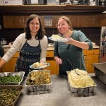 2 people serving dinner