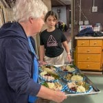 2 people serving dinner