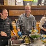 2 people serving dinner