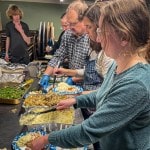 5 people serving dinner