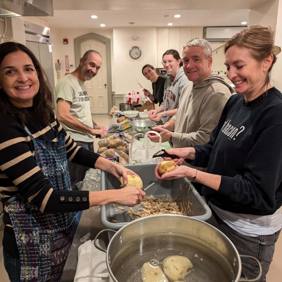 6 people making stuffing and mashed potatoes in the church kitchen