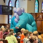 DinoMan inflatable dinosaurs in church sanctuary