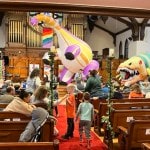 DinoMan inflatable dinosaurs in church sanctuary