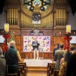 photo of church service with person giving sermon