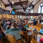 Church service with many congregants gathering to worship