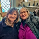 two women smiling at camera